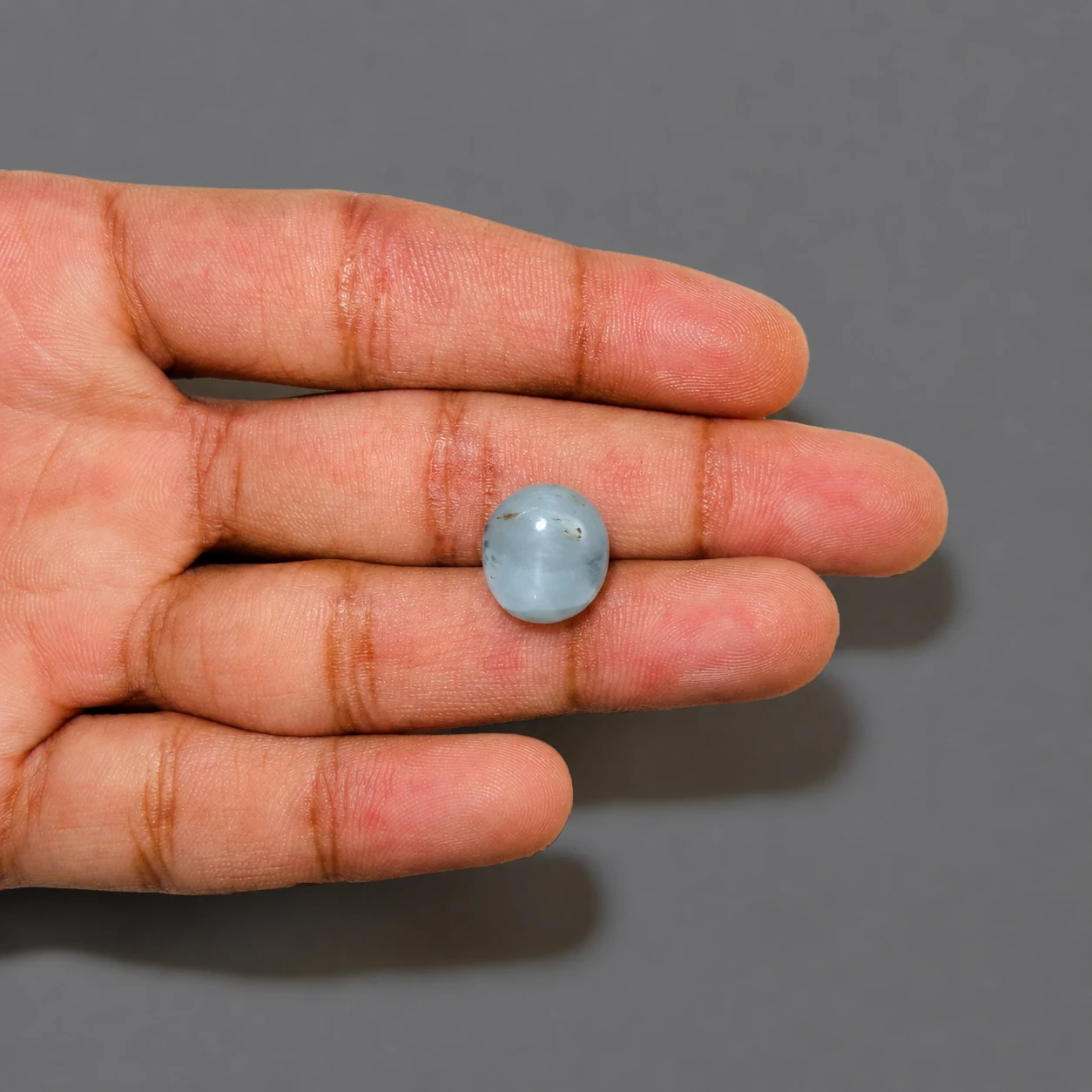 10.35 ct Natural Cat Eye (Lehsunia) gemstone with finger